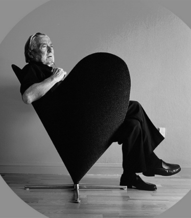 Verner Panton in a sculptural armchair, iconically staged in a monochrome, minimalist aesthetic.