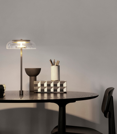 Elegant table lamp on a modern desk with stylish home accessories.
