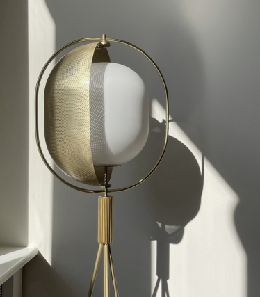 Sculptural 101 Copenhagen floor lamp with brass details and atmospheric light play.