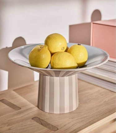 OYOY Living bowl with lemons on a stylish wooden table in soft pastel tones.